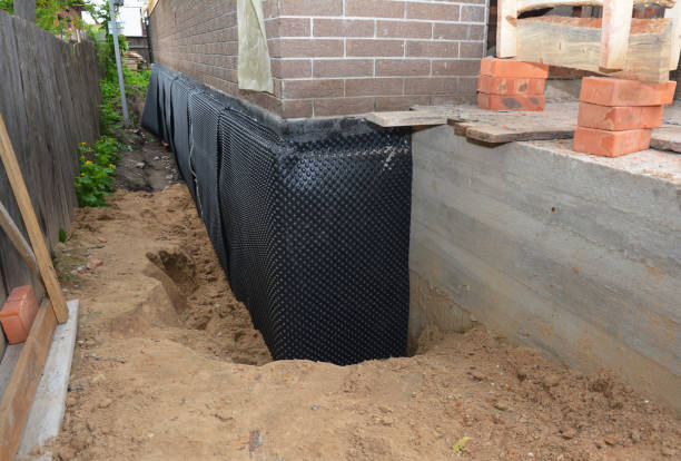 Happy homeowners after waterproofing job in Switz City